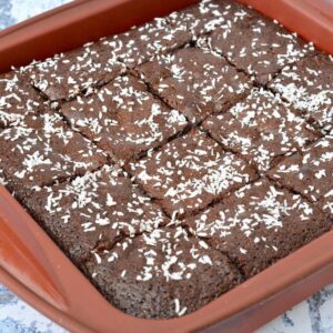A pan of fudgy coconut brownies cut into squares.