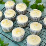 Lemon and white chocolate cakes cooling on wire rack with nettle tops.