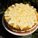 Passionfruit curd sponge cake filled with passionfruit buttercream and topped with orange icing.