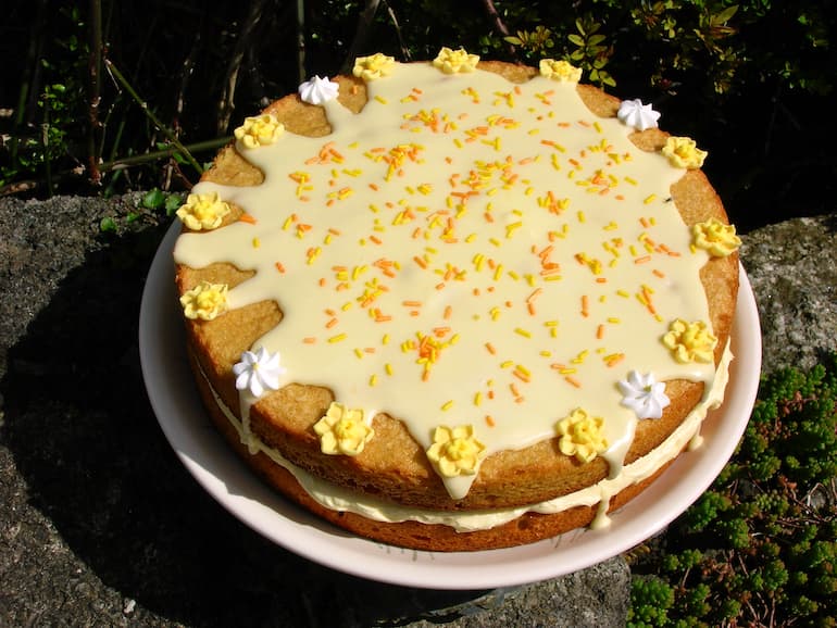 Passionfruit curd sponge cake filled with passionfruit buttercream and topped with orange icing.