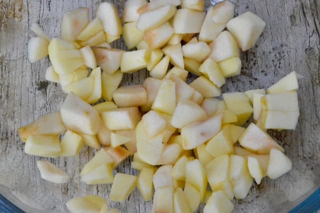 Chopped apples in a glass mixing bowl.