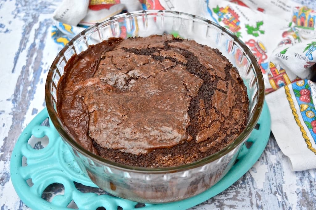 A glass dish of self-saucing chocolate pudding just out of the oven.