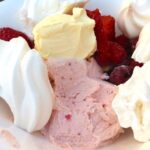 Roasted strawberry and white chocolate ice cream Eton Mess. With strawberries, raspberries, meringue and Cornish clotted cream.
