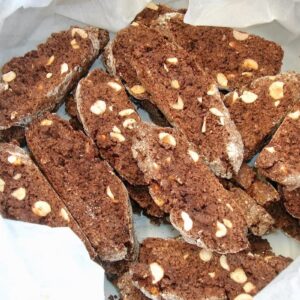 Chocolate, hazelnut biscotti in a tin lined with greaseproof paper.
