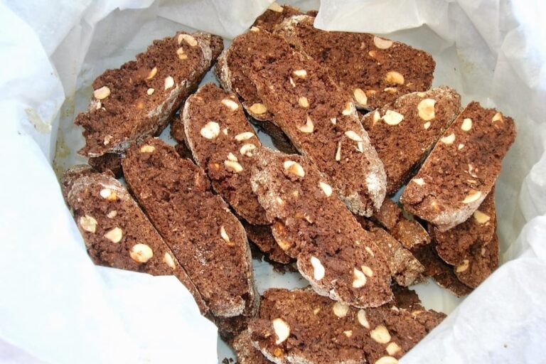 Chocolate, hazelnut biscotti in a tin lined with greaseproof paper.