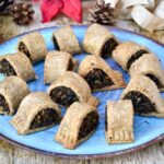 Homemade mushroom and chestnut vegetarian sausage rolls on a blue plate.