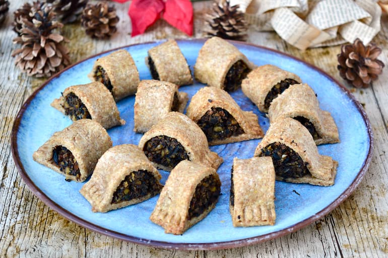 Homemade mushroom and chestnut vegetarian sausage rolls on a blue plate.