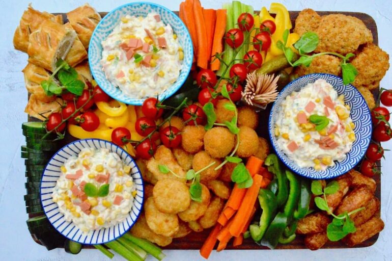 An easy to put together vegetarian party platter featuring three bowls of vegan smoky ham dip, various Quorn products and a selection of vegetable crudités.