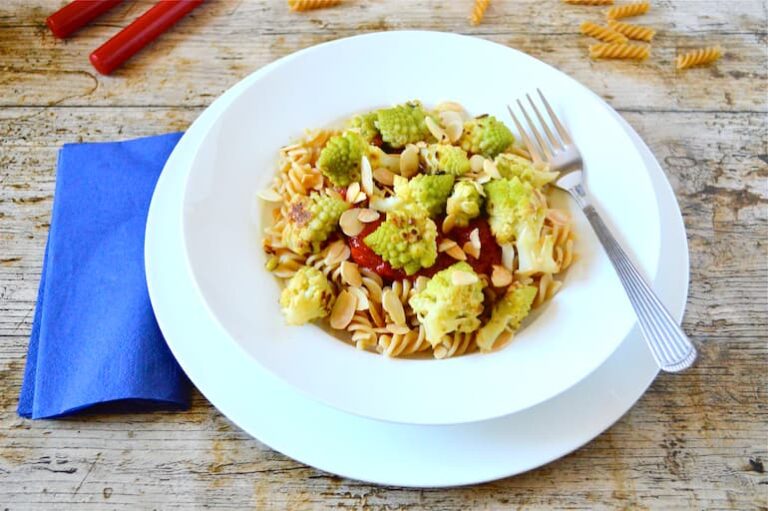 White bowl of lemon and garlic romanesco pasta with fork.