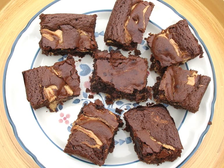 A blue patterned plate full of healthy (ish) cashew nut butter brownies.
