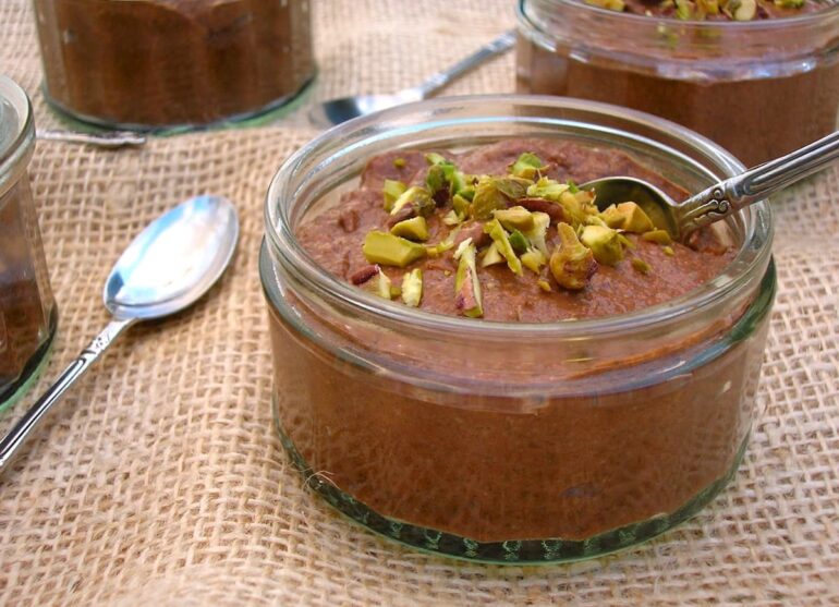 Chocolate Chia Pudding with chopped pistachios on top and an apostle spoon.
