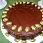 Chocolate Guinness cake decorated with gold foil covered mini Easter eggs.