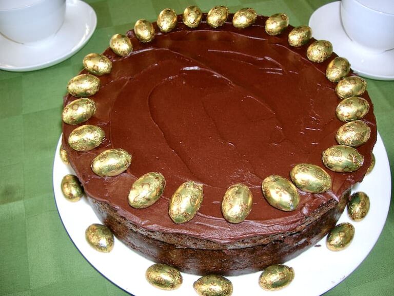Chocolate Guinness cake decorated with gold foil covered mini Easter eggs.