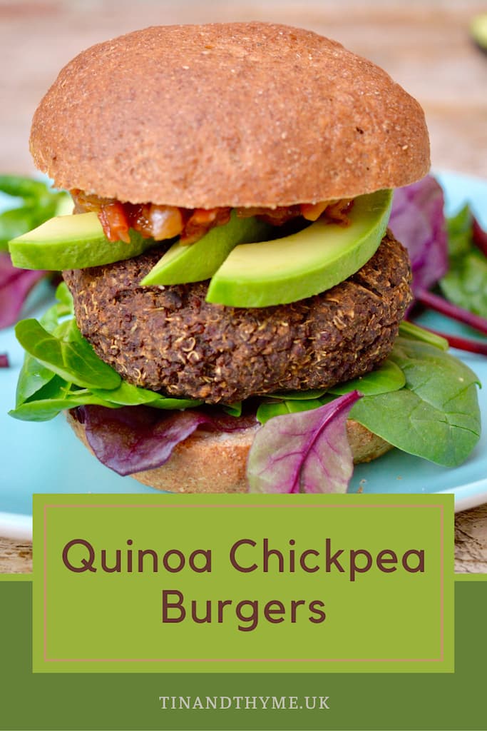 Red quinoa chickpea burger in a wholemeal bun with avocado slices, tomato and onion relish and salad leaves.