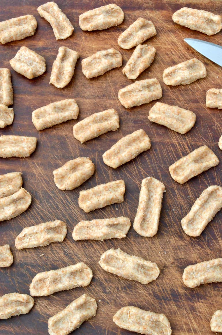 Board full of homemade whole wheat vegan cavatelli pasta dough.