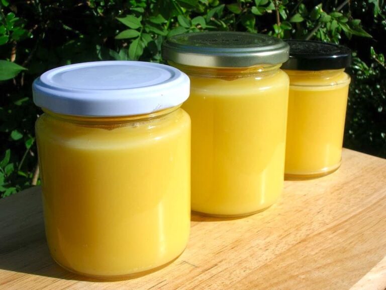 Three jars of apple lemon curd sitting in a row.