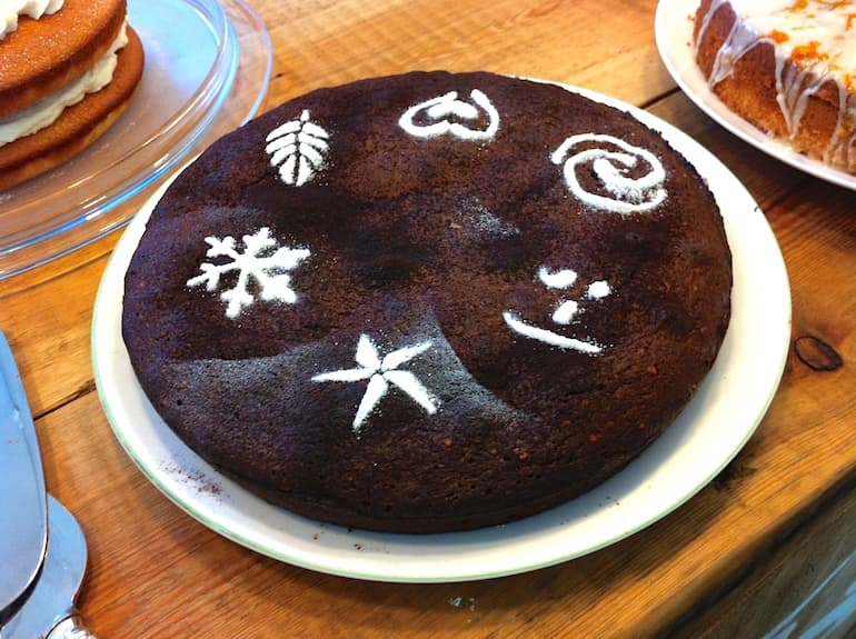 Chocolate hazelnut torte decorated with icing sugar patterns.