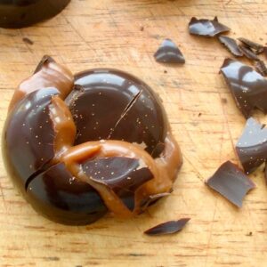 A purposefully cracked homemade passionfruit caramel chocolate.