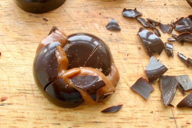 A purposefully cracked homemade passionfruit caramel chocolate.