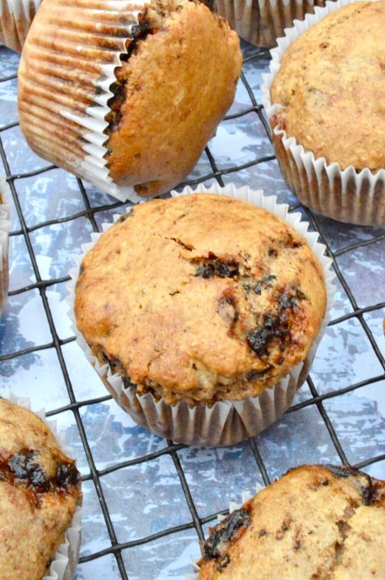 Close up of whole wheat vegan mincemeat muffins cooling on a wire rack.
