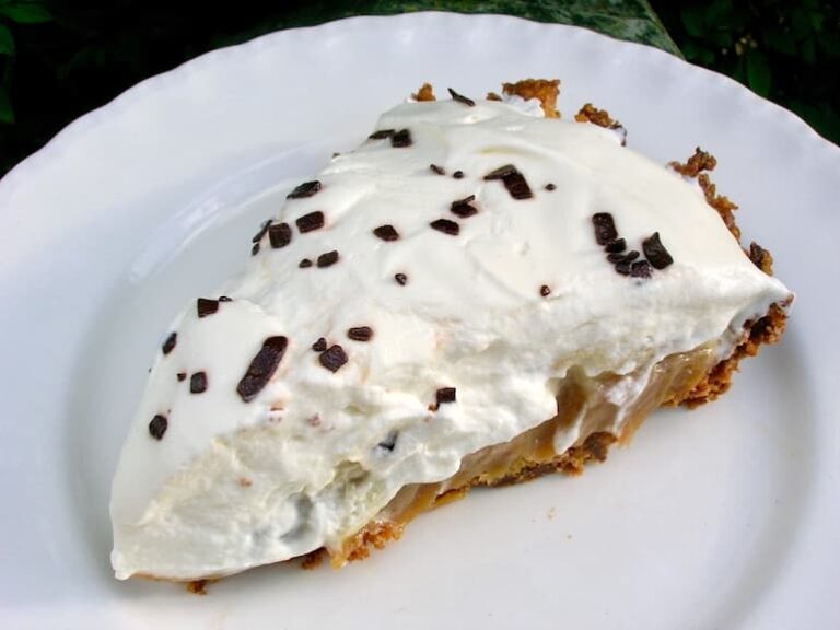 A slice of banoffee pie on a white plate.
