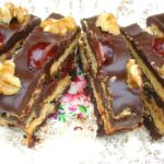 Slices of chocolate Amaretto biscuit cake with glacé cherries and walnuts on the top. Also known as tiffin.