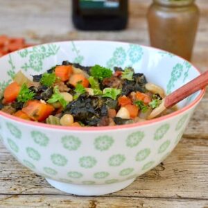 Close up of a bowl of ribollita: a hearty vegan Tuscan soup - with spoon.