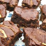 Close up of a blue patterned plate full of healthy (ish) cashew nut butter brownies.