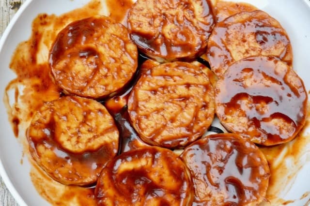 Tempeh slices in punchy marinade.