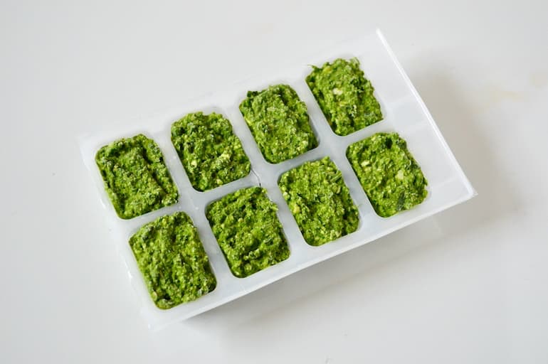 Pesto in ice cube trays ready for freezing.