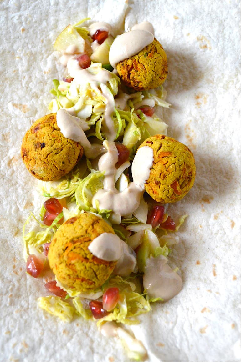 Air fryer carrot falafel on flat bread with salad and tahini sauce.