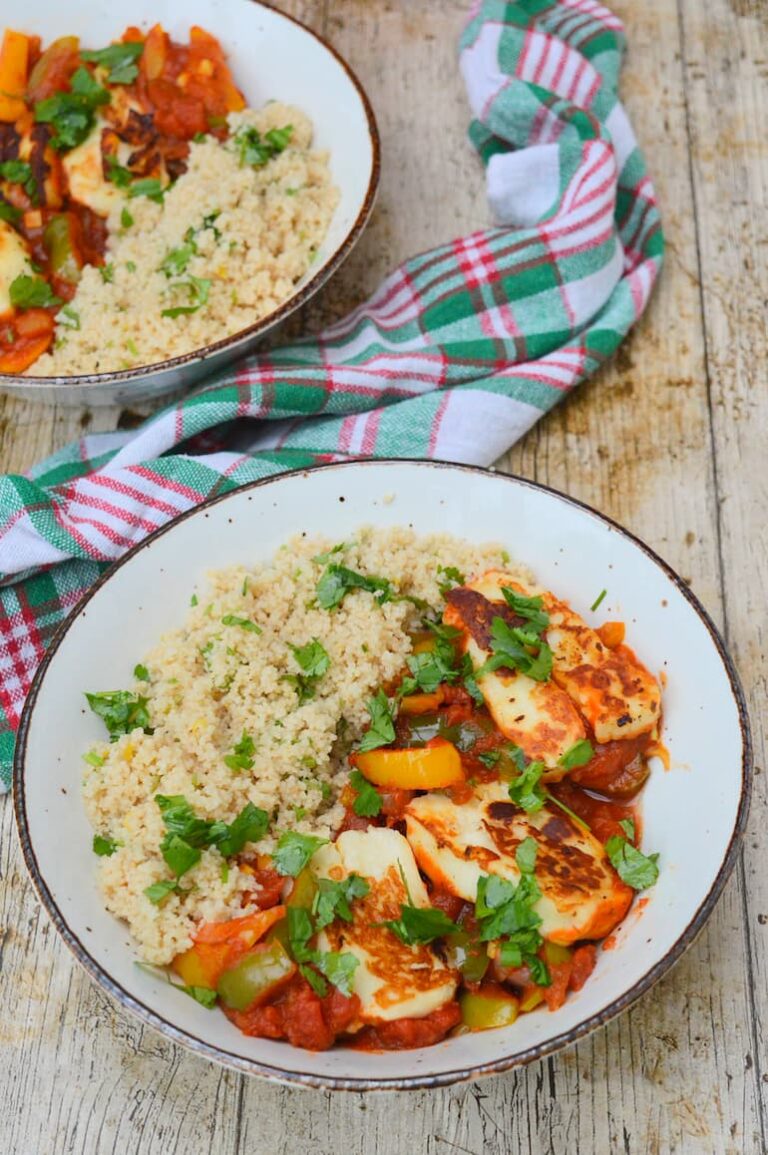 Two bowls of halloumii shakshuka with herby couscous.