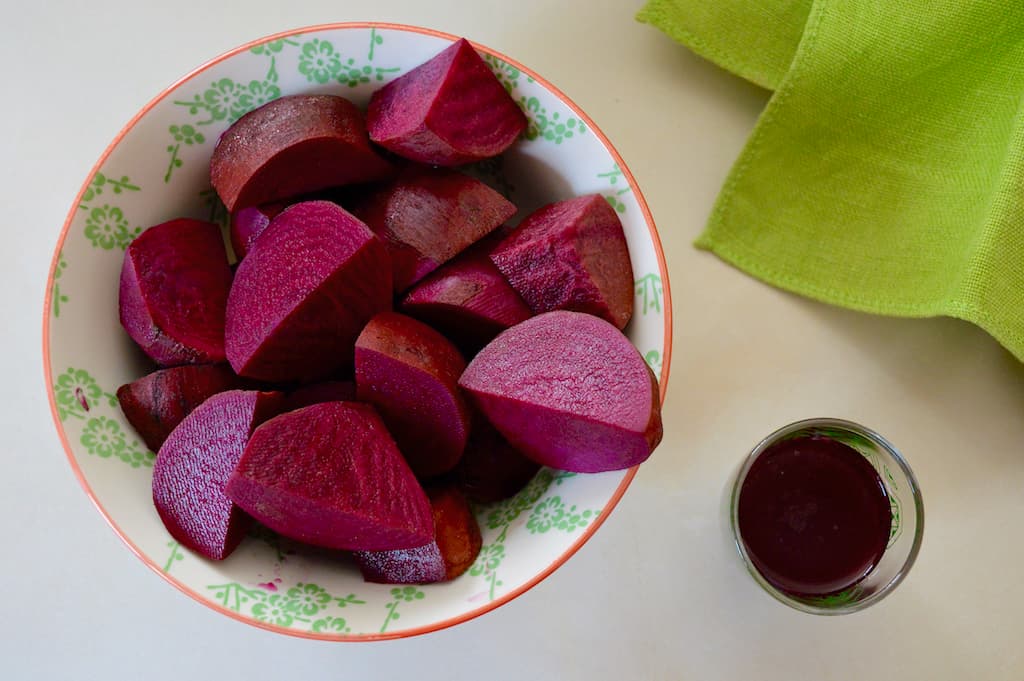 A bowl of roughly chopped lacto-fermented beetroot.