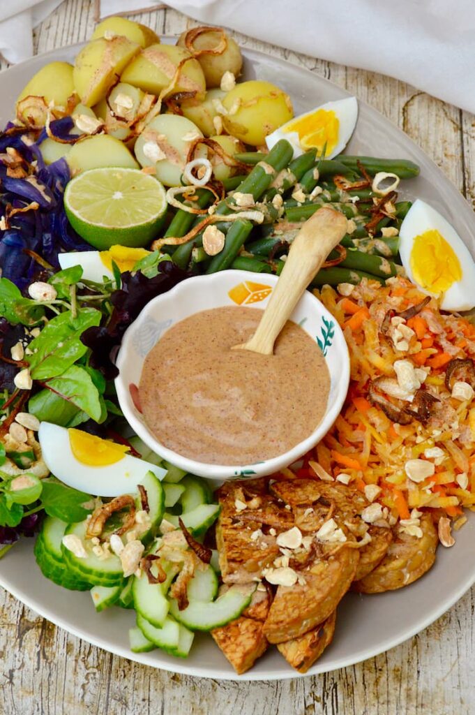 Gado gado Indonesian salad platter complete with bowl of spicy peanut sauce.