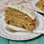 A slice of courgette cake with lime and mascarpone frosting.
