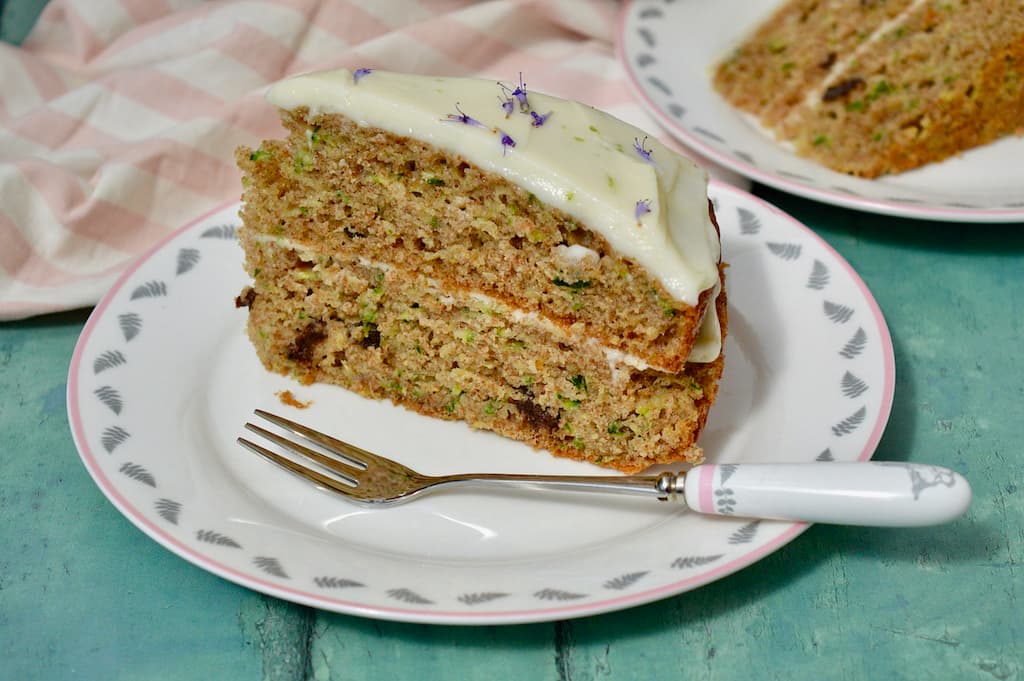 A slice of courgette cake with lime and mascarpone frosting.