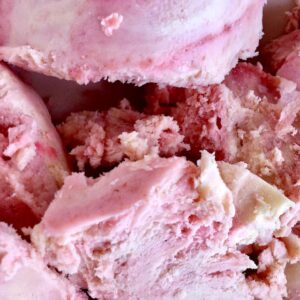 Close up of homemade redcurrant ripple ice cream in a bowl.