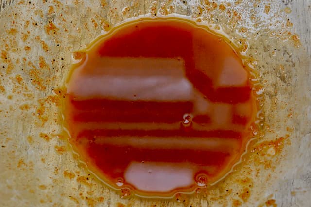 Spanish vinaigrette in glass mixing bowl.