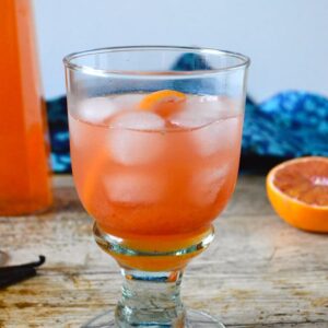 A glass of blood orange squash with ice.