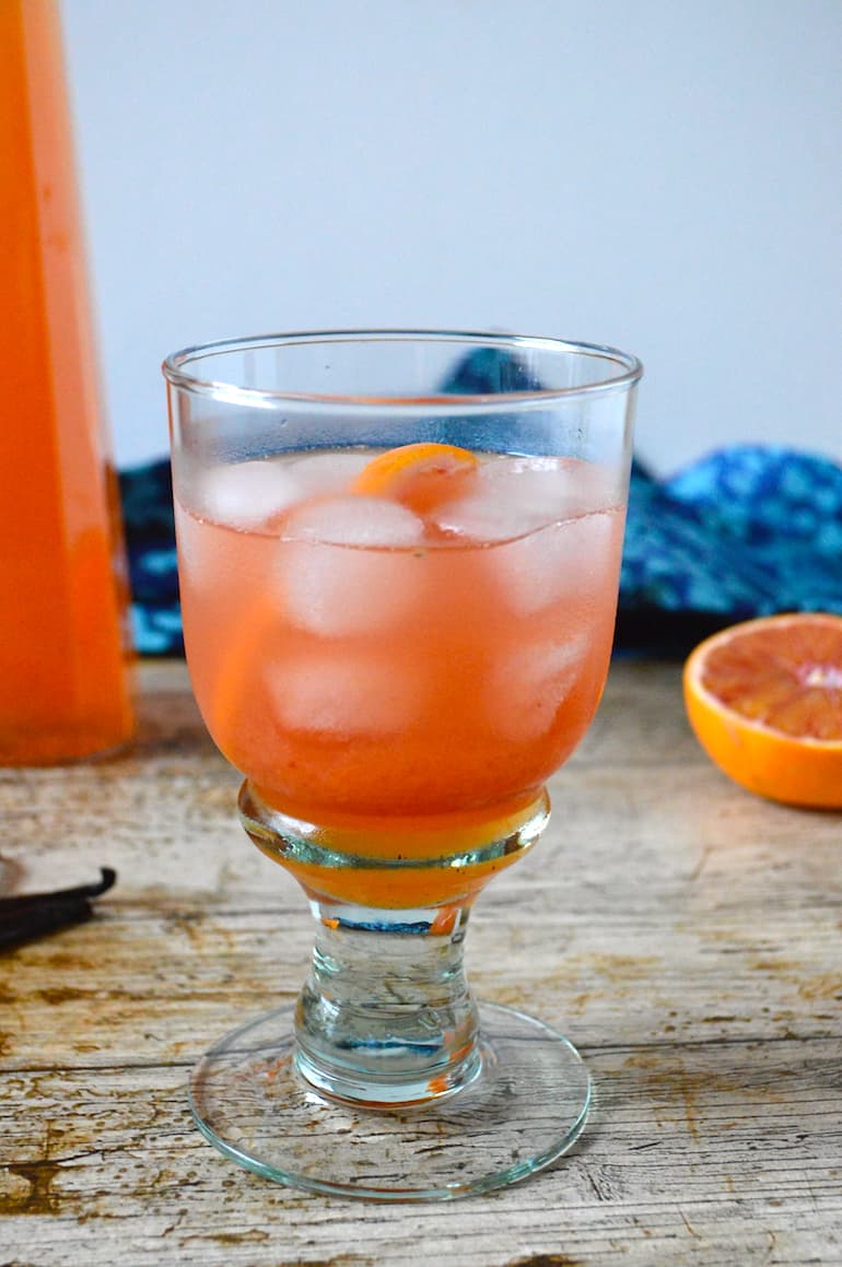A glass of blood orange squash with ice.