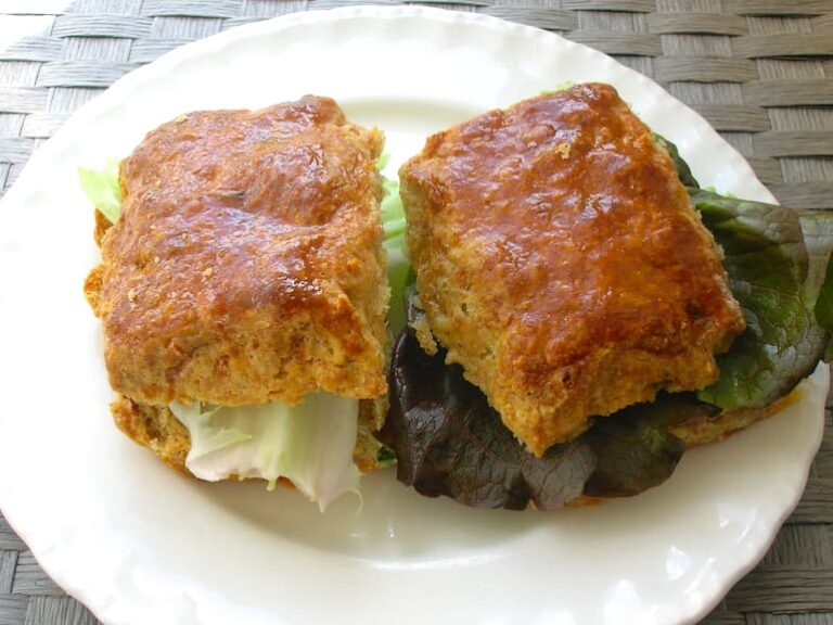Two brie and chive cheese scones sandwiched with lettuce.