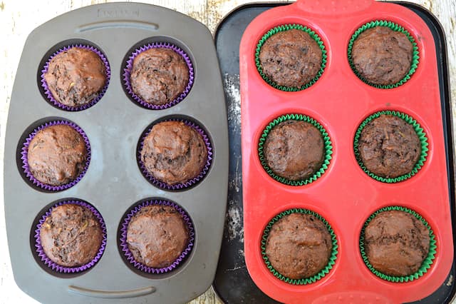 Baked chocolate courgette muffins in moulds, just out of oven.