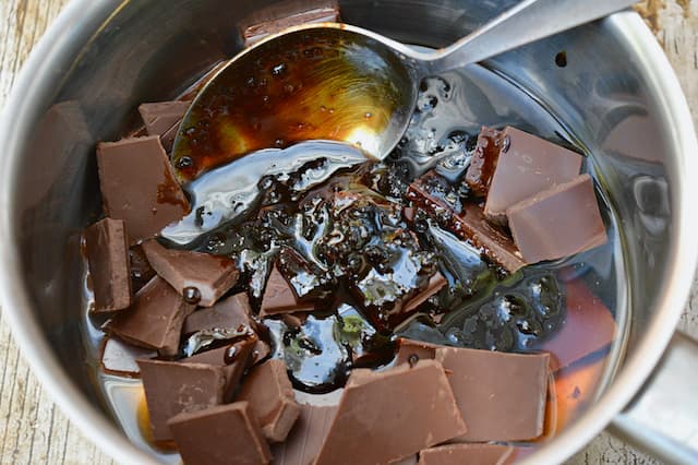 Ingredients for chocolate water ganache in a pan with spoon.