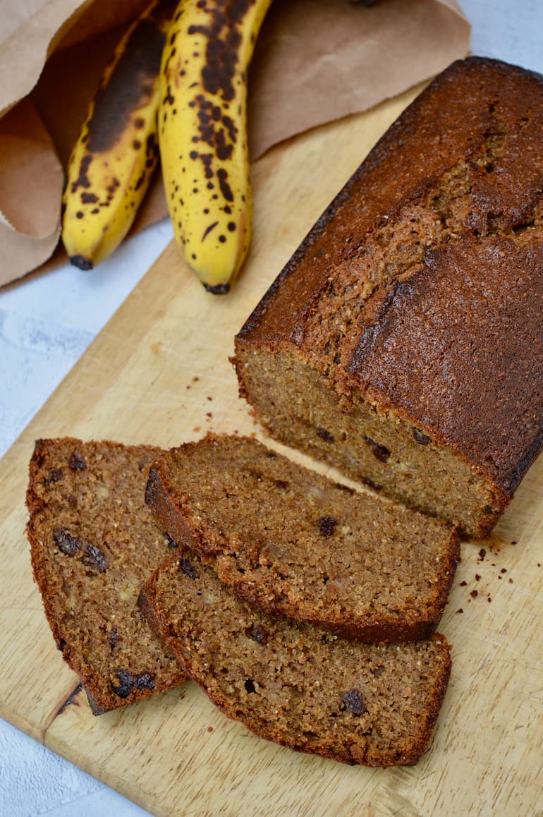 Three slices from a loaf of muscovado banana bread. And a couple of bananas at the back.
