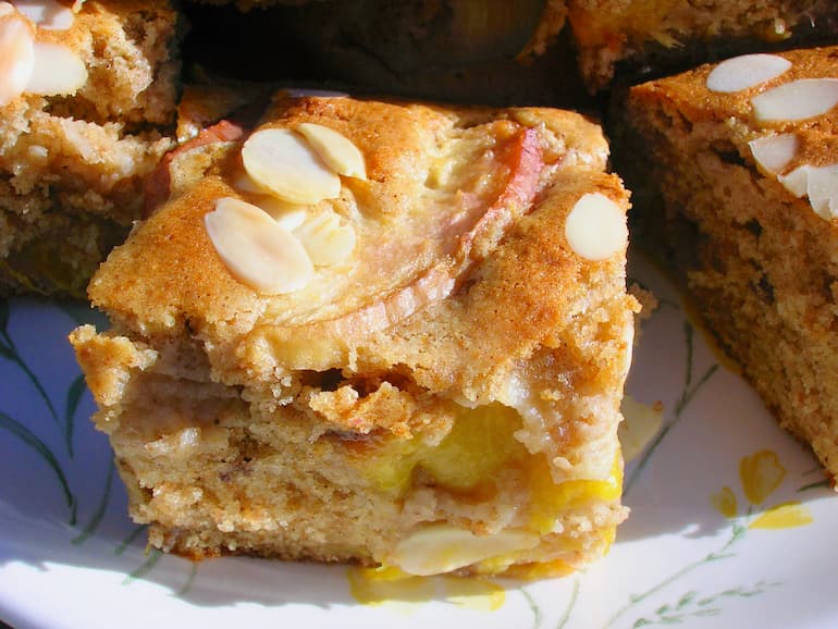 A square of peach and white chocolate cake.