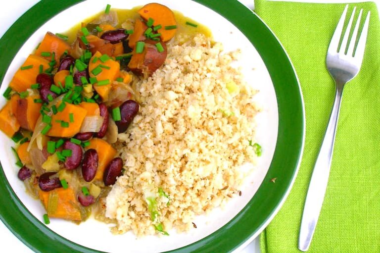A plate of cauliflower rice with jerk sweet potato curry.