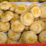 Chinese walnut cookies piled into a biscuit tin.