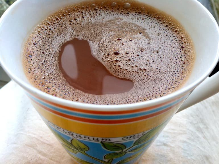A mug of cocoa made with water and a dash of milk.