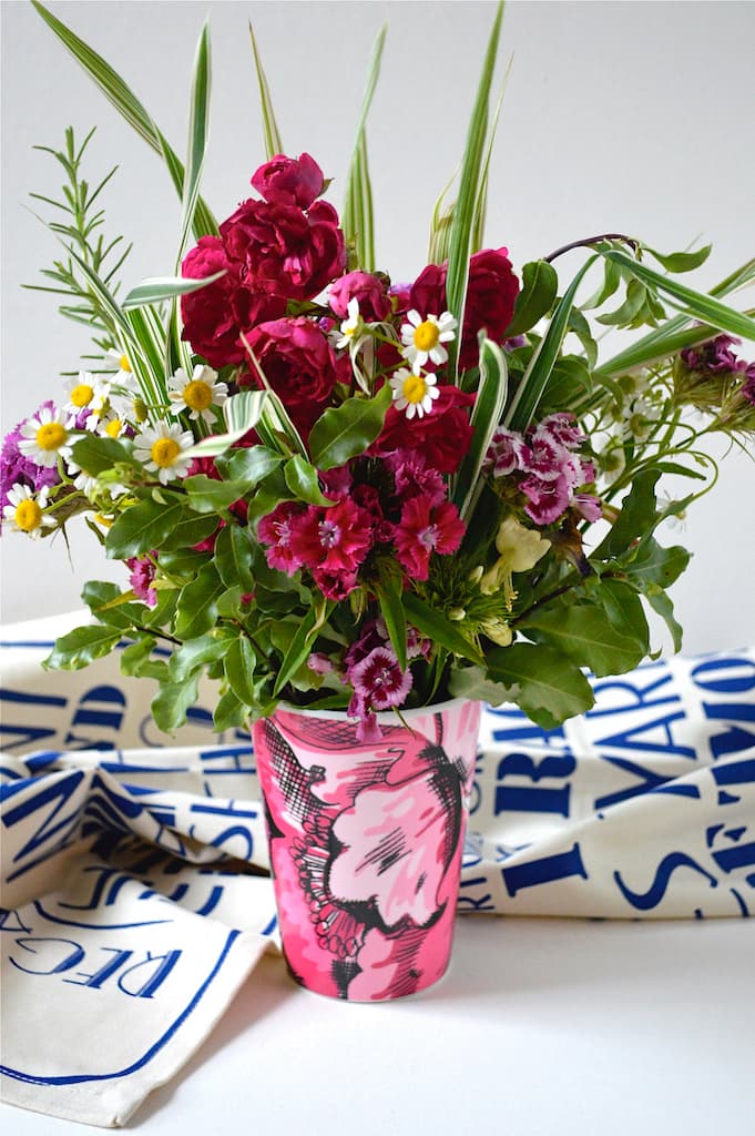 Pink Jules beaker filled with garden flowers.