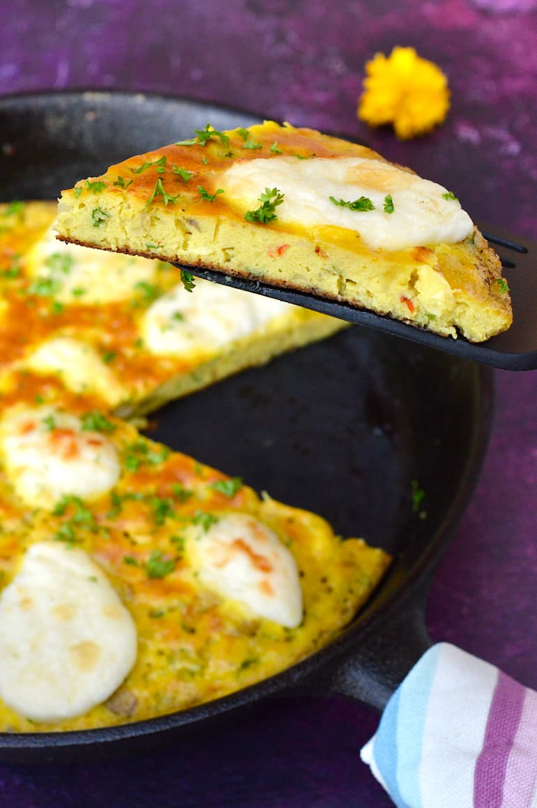 A slice of leftover mashed potato omelette lifted up over the main pan.